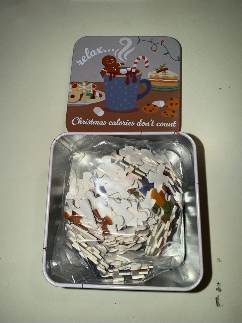Relax Christmas Cookie Tin - Festive Brown Holiday Treats contains puzzles